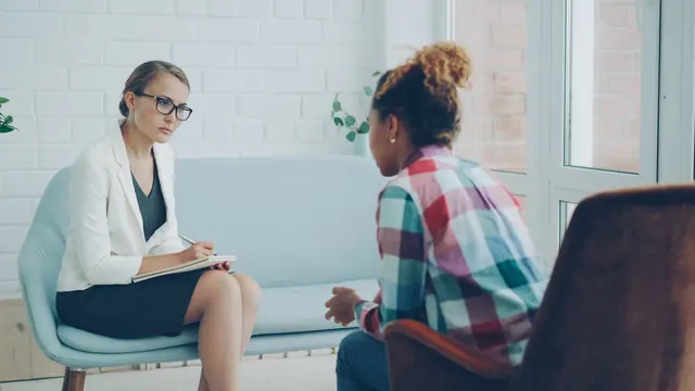 A therapist listening to a patient during a consultation