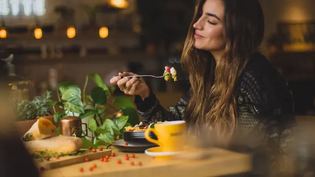 A woman sharing a meal at a table