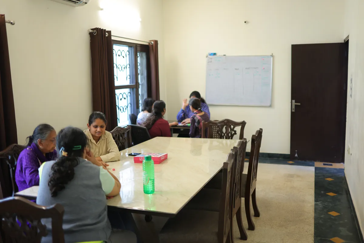A counselling group around a table at the Mehrauli centre
