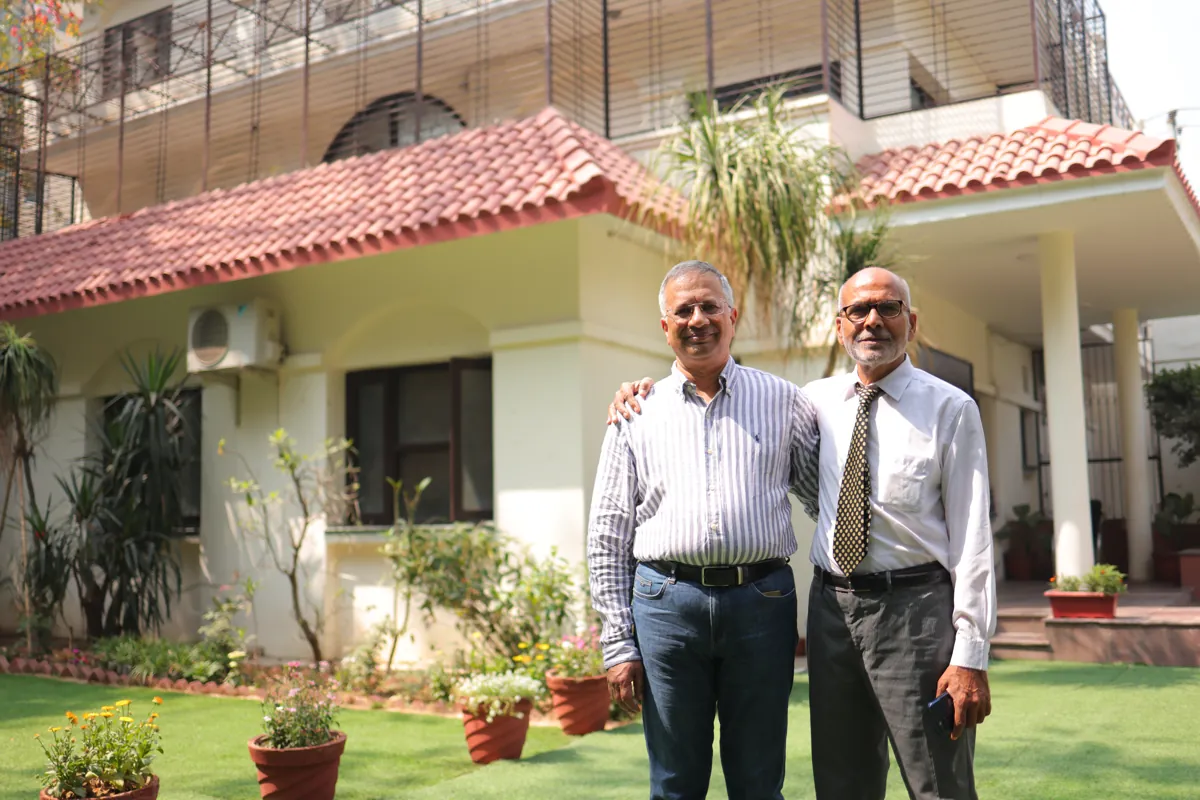 Two doctors standing together in the garden at the Mehrauli centre