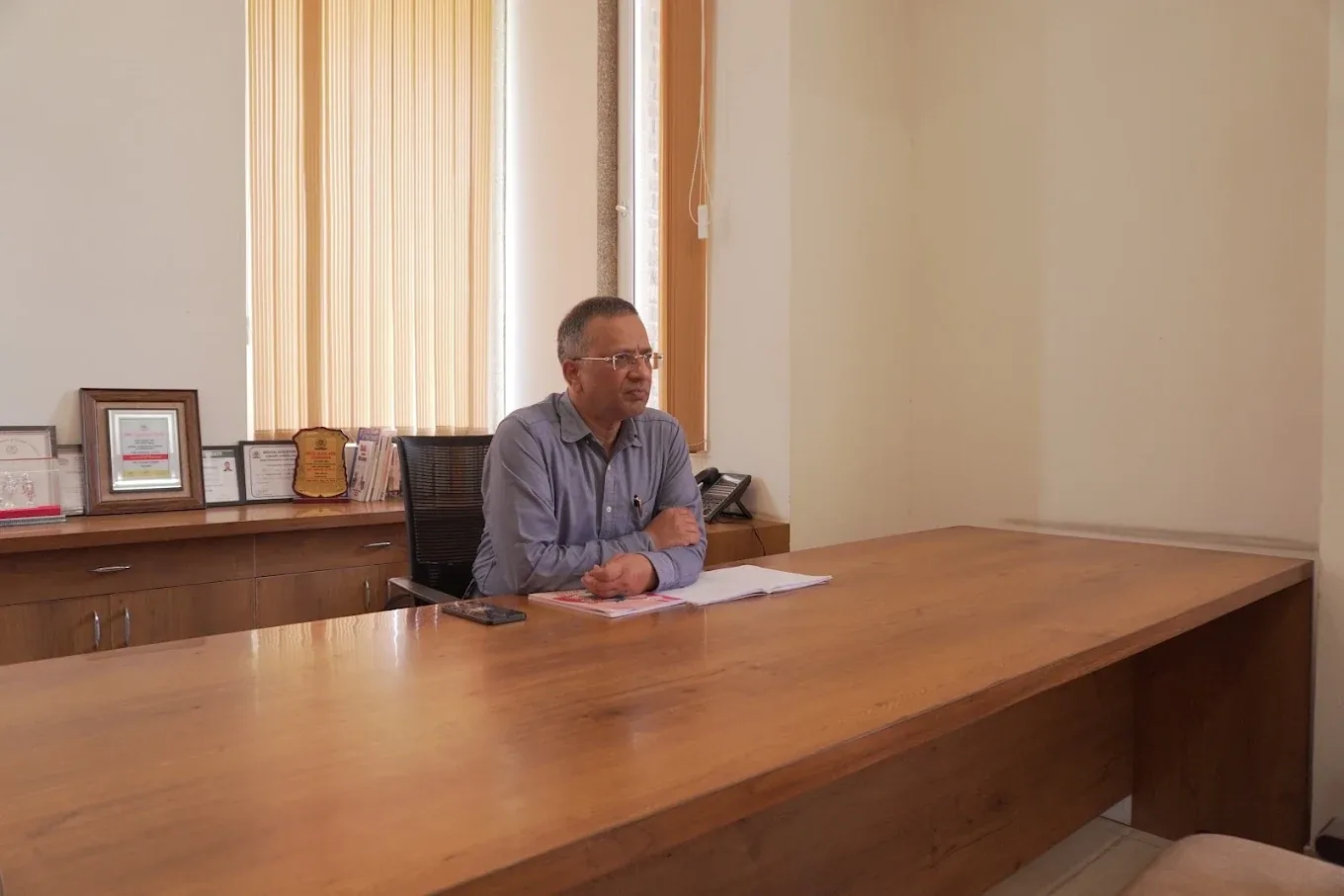 Dr. Gorav Gupta at his desk in the consulting room