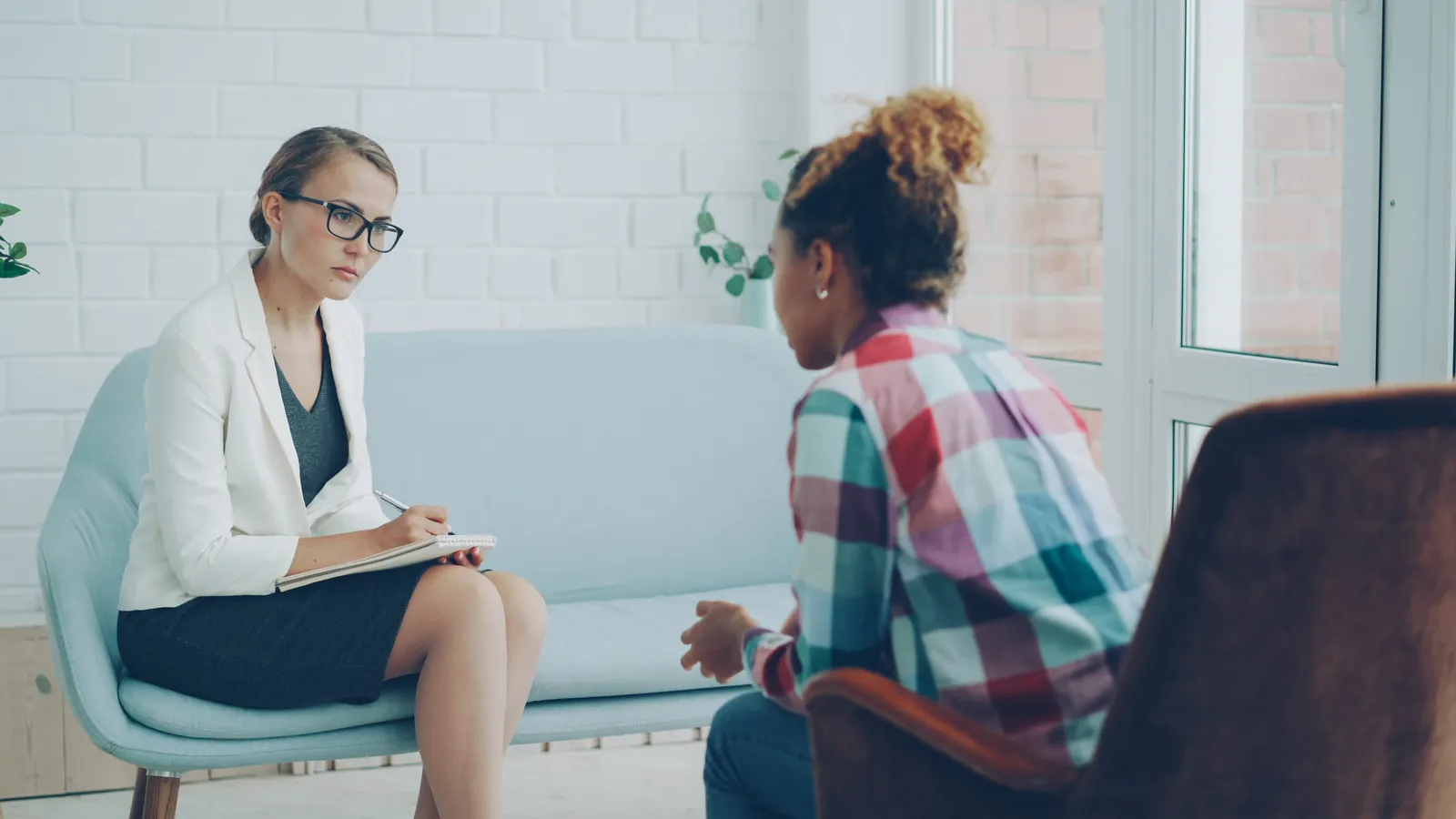 Therapist listens to patient in a counseling session tw mAZXr6H4